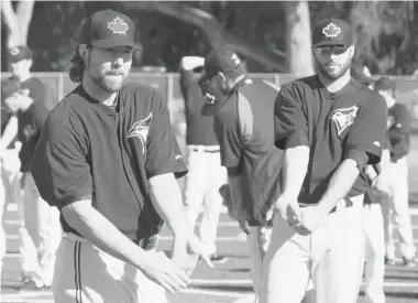  ?? FRANK GUNN/The Canadian Press ?? Toronto Blue Jays starting pitchers R.A. Dickey, left, and Brandon Morrow stretch on the first official day of spring training
on Monday in Dunedin, Fla.