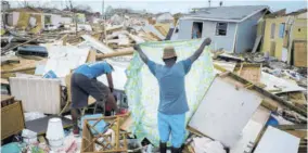  ?? (Photo: AP) ?? Immigrants from Haiti recover their belongings from the rubble in their destroyed homes, in the aftermath of Hurricane Dorian in Abaco, Bahamas, Monday, September 16, 2019. Dorian hit the northern Bahamas on September 1, with sustained winds of 185 mph (295 kph), unleashing flooding that reached up to 25 feet (8 meters) in some areas. Caribbean tourism interests are concerned about the impact of hurricanes in the region.