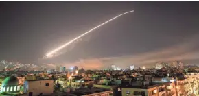  ?? HASSAN AMMAR/AP ?? Missile fire lit up the sky over Damascus, Syria, April 14 as the U.S. and allies launched an attack on chemical weapons sites.