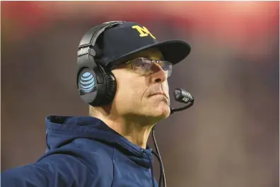  ?? CHRISTIAN PETERSEN/GETTY ?? Michigan coach Jim Harbaugh has his Wolverines in position for a third straight berth in the College Football Playoff.