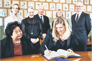  ??  ?? Thurlow (seated left) looks on as leader of ICAN, Beatrice Fihnon signs the Nobel protocol in Oslo, Norway. Standing from left are Members of the Norwegian Nobel Committee, chairman Inger-Marie Ytterhorn, Berit Reiss-Andersen, Torbjorn Jagland, Tone...