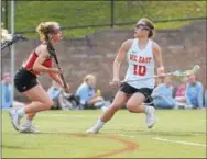  ?? PETE BANNAN — DIGITAL FIRST MEDIA ?? West Chester East’s Morgan Catrambone looks for an opening against Haverford High’s Carly Gannon in the first half of their season-opening girls lacrosse game Friday. The Fords posted a 16-7 victory.