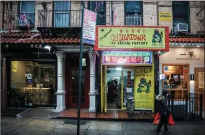  ?? (AP/Bebeto Matthews) ?? A woman earlier this month walks past Chinatown Ice Cream Factory, a neighborho­od fixture owned by Christina Seid and founded by her father four decades ago in New York.