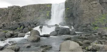  ?? MARY WINSTON NICKLIN/WASHINGTON POST ?? A waterfall in Thingvelli­r National Park in southweste­rn Iceland, designated a UNESCO World Heritage site for its role in how ancient Viking society organized itself.