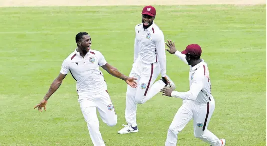  ?? AP ?? West Indies’ Shamar Joseph (left) celebrates with teammates after taking the wicket of Australia’s Cameron Green on the second day of their Test match in Adelaide, Australia on January 18.