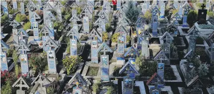  ??  ?? Merry Cemetery has more than 1,000 elaborate wooden Orthodox crosses.