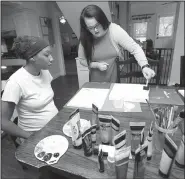  ?? NWA Democrat-Gazette/ANDY SHUPE ?? Sade Danie (left) and intern Jess Perry prepare to paint canvases June 29 as a thank you for donors at Compassion House in Elm Springs. Danie is the first 18-year-old woman to move into Compassion House, a home for pregnant teens, after a June 11...