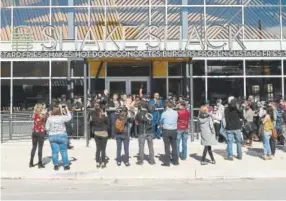  ??  ?? Customers line up to get a Shake Shack meal before 11 a.m. Wednesday.