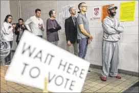  ?? JOHN SPINK / JSPINK@AJC.COM ?? Voters lined up early Tuesday at Henry W. Grady High School in Atlanta to cast their votes. Only about 20,000 of 250,000 registered voters cast early ballots in Atlanta’s mayoral election, a likely sign of low turnout for Tuesday’s vote to succeed...