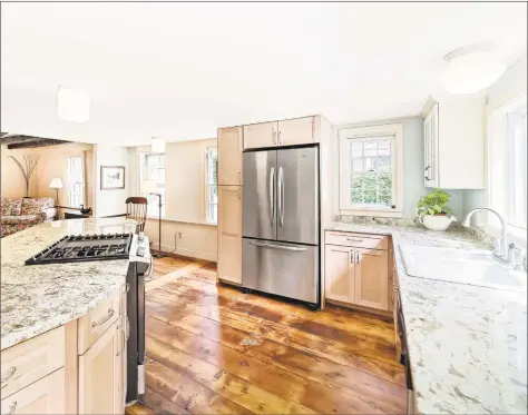  ?? Coldwell Banker Residentia­l Broker ?? The stunning gourmet kitchen at 111 North St. in Milford features wide plank flooring and a center island. The Sanford Bristol House is listed on The National Register of Historic Places and has been restored and updated by the current owner.