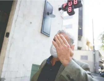  ?? MIKE BELL ?? Karl Richard Antonius raises his hand to cover his face after leaving Supreme Court in Vancouver on Friday. He unsuccessf­ully used the defence of `sexsomnia' in his sexual assault trial. He will be sentenced Oct. 9.