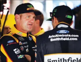  ?? AP PHOTO BY COLIN E. BRALEY ?? NASCAR driver Clint Bowyer, left, talks with Aric Almirola before practice at Kansas Speedway in Kansas City, Kan., Friday, Oct. 19.