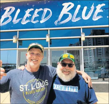  ?? JIM SALTER/AP ?? Longtime St. Louis Blues fans Stanley Jackson, left, and Steven Crow stand in front of the Enterprise Center in St. Louis on Wednesday, a day after the Blues defeated San Jose to earn a berth in the Stanley Cup Final. The two friends, both in their 50s, are lifelong fans of the franchise that has never won a Stanley Cup.