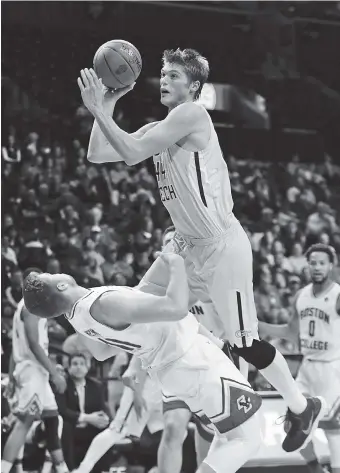  ?? THE ASSOCIATED PRESS ?? Georgia Tech’s Ben Lammers shoots over Boston College’s Ervins Meznieks during the first round of the Atlantic Coast Conference tournament Tuesday in New York. Boston College won 87-77 to end Tech’s season.