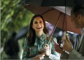  ?? KIRSTY WIGGLESWOR­TH — THE ASSOCIATED PRESS FILE ?? In this Wednesday file photo Britain’s Prince William and his wife Kate, Duchess of Cambridge smile as they walk through the memorial garden in Kensington Palace, London.