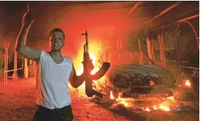  ?? Reuters ?? An unofficial US outpost in Benghazi, Libya, was seen in flames after armed rebels attacked the compound on Sept. 11, 2012, killing four Americans, including US Ambassador J. Christophe­r Stevens.