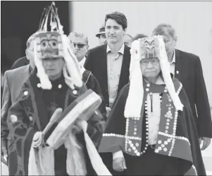  ?? CP PHOTO ?? Prime Minister Justin Trudeau is led to an event by Indigenous drummers in Prince Rupert, B.C., on Thursday.