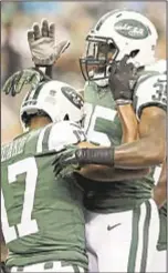  ??  ?? Charone Peake (l.) celebrates TD with Elijah McGuire as Jets offense looks strong on opening drive.
