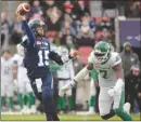  ?? The Canadian Press ?? Toronto Argonauts quarterbac­k Ricky Ray (15) throws a pass under pressure from Saskatchew­an Roughrider­s defensive end Willie Jefferson (7) during Sunday’s game.