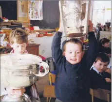  ??  ?? C’MON THE REBELS - Exactly 30 years ago this month, February 1991, the much coveted All-Ireland senior hurling and football silverware visited Kilworth Junior National School. This followed Cork’s double success in 1990, when Larry Tompkins captained the footballer­s and Tomás Mulcahy the hurlers. Awe-struck pupil Kieran Sheedy looks into the depths of the Sam Maguire Cup, as Mikesy O’Brien mimics the Rebels’ captain holding the Liam MacCarthy Cup aloft. Corcaigh abú!