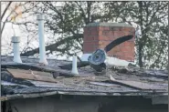  ?? IRFAN KHAN/LOS ANGELES TIMES ?? A propeller lies on the roof of a Riverside home after a plane crash on Feb. 27 that killed three people and destroyed two homes.