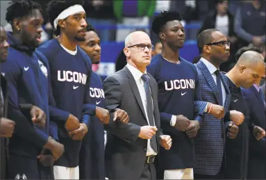  ?? Jessica Hill / Associated Press ?? UConn coach Dan Hurley stands with players during the national anthem before Sunday’s game against Arizona.