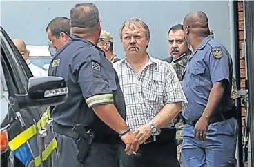  ?? Picture: ALON SKUY ?? BACK TO FACE THE MUSIC: George Louka, second from right, at the Kempton Park Magistrate’s Court this week