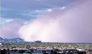 ?? ASSOCIATED PRESS FILE PHOTO ?? A large dust storm, or haboob, sweeps across downtown Phoenix in 2012. Drought is tightening its grip across a wide swath of the American Southwest as farmers, ranchers and water managers throughout the region brace for what’s expected to be more warm...