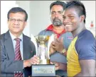  ??  ?? St Peter’s skipper Kevin Dickson receiving the trophy Brig. Udaya Ariyaratne, Principal of Trinity and Vice President of SLSRFA watched by Susantha Mendis, Secretary SLSRFA.