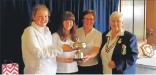  ??  ?? The victorious Oban triples team receive their trophy from Anne Marie Sullivan, president of the West of Scotland Women’s Bowling Associatio­n.