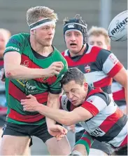  ??  ?? Going forward: Highland’s Oscar Baird is tackled by James Gibson of Stirling during the cup tie