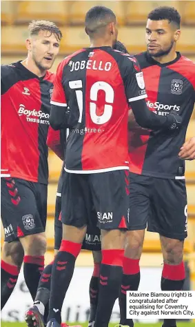  ??  ?? Maxime Biamou (right) is congratula­ted after equalising for Coventry City against Norwich City.