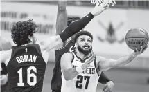  ?? Tony Dejak, The Associated Press ?? Denver’s Jamal Murray drives to the basket against Cleveland’s Cedi Osman on Friday night.