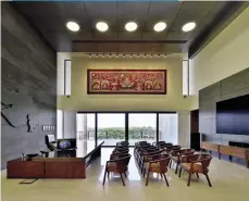  ??  ?? STUNNING SPACES
Subtle yet bold interiors of a double height living room in a high end housing society in Ahmedabad (left); CM’s office at Sachivalay in Gandhinaga­r, highlighti­ng rich culture of the state (below); both designed by HCP Interior Design