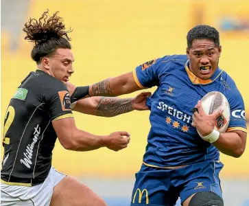  ?? GETTY IMAGES ?? Otago’s Sione Misiloi fends off Peter UmagaJense­n yesterday.
