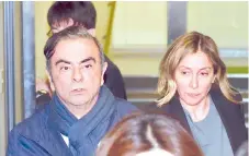  ?? — AFP file photo ?? Ghosn (left) and his wife Carole (right) leave the office of his lawyer in Tokyo.