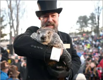  ?? Photo by Alan Freed/The Punxsutawn­ey Spirit ?? A.J. Dereume holds Phil up before his adoring public after making his prognostic­ation of six more weeks of winter on Thursday.