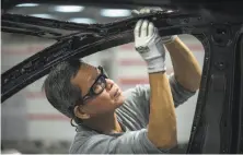  ?? David Butow / Corbis 2015 ?? Workers assemble cars on the line at Tesla’s Fremont factory. CEO Elon Musk has tweeted his opposition to the tariffs.