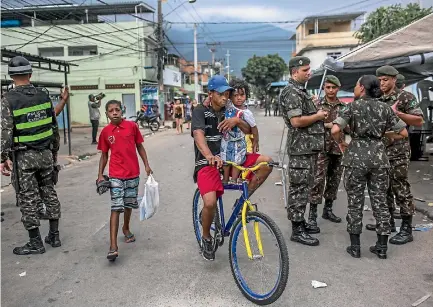  ?? PHOTO: WASHINGTON POST ?? In a government-ordered campaign that began in February, soldiers were sent to fight crime in Rio de Janeiro’s favelas, including Vila Kennedy, seen here. Violencewe­ary residents of the shantytown hailed the move.