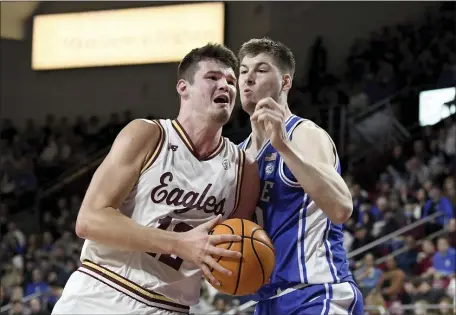  ?? MARK STOCKWELL — THE ASSOCIATED PRESS ?? Boston College’s Quinten Post, left, runs into Duke’s Kyle Filipowski during the second half of the ACC men’s basketball clash. BC fell 65-64 in a thrilling game.