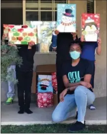  ?? COURTESY PHOTO ?? Geneva Perry, executive director and founder of Great Encouragem­ent Movement, delivers Christmas gifts to a foster home in Moreno Valley.