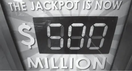  ?? MIKE SEGAR/REUTERS ?? The Mega Millions lottery jackpot is seen on a New York City phone booth on Thursday. The jackpot is at an all-time record of more than $500 million.