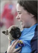  ??  ?? Aoibhe Drennan keeps Bubba safe and warm while watching the races.