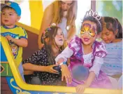  ??  ?? Soleil Sooh, 5, dressed as a princess, throws a plastic ball at a pirate ship during the Renaissanc­e Faire.