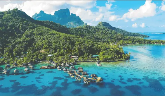  ?? PHOTOS: GETTY IMAGES ?? Thatched-roof overwater bungalows in Bora Bora offer the ultimate in relaxing in luxury while taking in the splendour of a turquoise lagoon.