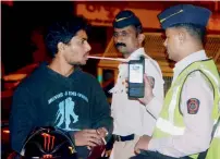  ?? PTI file ?? Police check a motorist with breath analysers in Mumbai. —