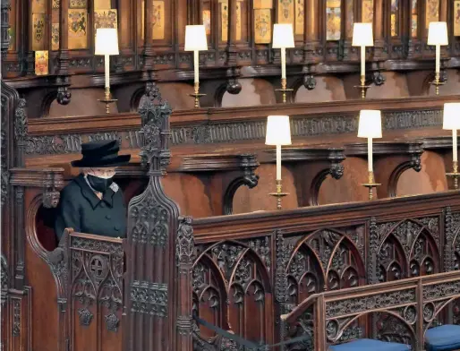  ?? AP ?? Queen Elizabeth looks on as she sits alone in St. George’s Chapel during the funeral of Prince Philip at Windsor Castle, Windsor, England, on Saturday. —