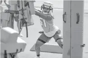  ?? AL DIAZ adiaz@miamiheral­d.com ?? Linebacker Channing Tindall works with practice dummies during Dolphins’ Rookie Minicamp on Saturday.