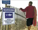  ?? AP FILE PHOTO ?? Steve McFadden, 49, of Plattsburg­h, N.Y., gazes Aug. 16 at Long Nook Beach in Truro, Mass., on Cape Cod, which was closed to swimmers after a man was attacked by a shark the previous afternoon.