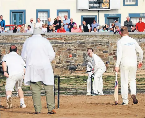  ??  ?? ALUMNI spanning four decades from the University of Dundee took on the Ship Inn Cricket Club on the sands of Elie in a match celebratin­g the 50th anniversar­y of the university.
Twelve alumni and one staff member took to the wicket of The Ship Inn CC...